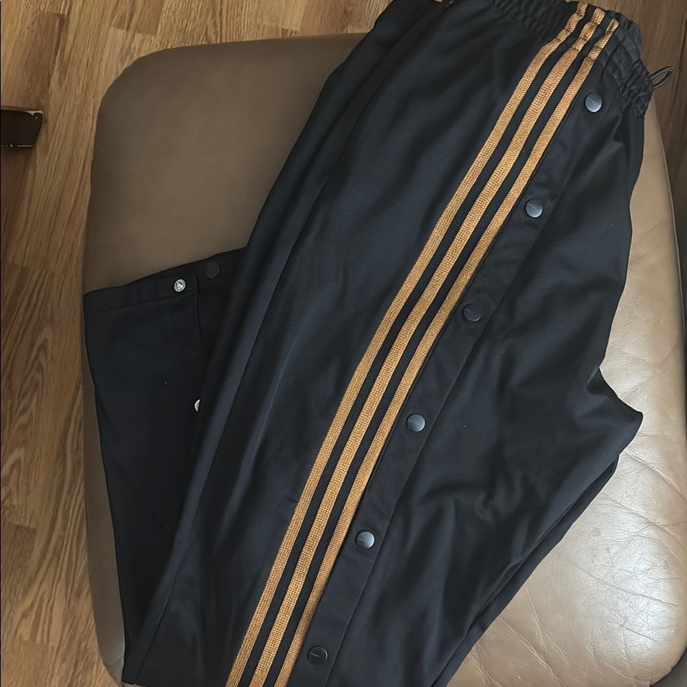Adidas Ivy Park Black and Gold Sweatpants with Vertical Stripes